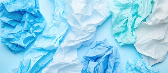 Wall Mural - crumpled blue and white paper background with texture and copy space