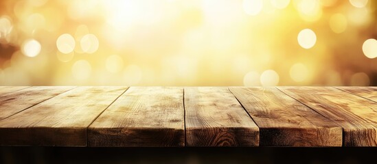 Wall Mural - wooden table with warm golden bokeh background and copy space