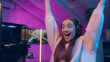 © Yuliia - Happy Caucasian girl woman winner playing virtual game computer speaking microphone influencer female gamer winning match cyber sport gold champion receive cup addict streamer celebrate at home neon