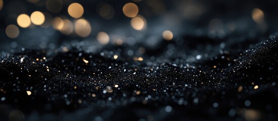 Wall Mural - Close-up of textured black surface with golden and silver glitter particles and bokeh background Copy Space