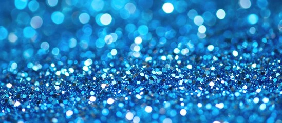 Wall Mural - Blue glitter textured background with bokeh effect for decorative purposes or creative designs Copy Space