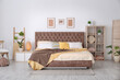 © New Africa - Cozy bedroom interior with mocha mousse shade. Trendy color of 2025 year