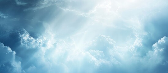 Wall Mural - blue sky with white fluffy clouds illuminated by sunlight beams creating a soft and tranquil atmosph