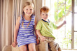 © peopleimages.com - Happy, relax and portrait of kids in home for playing, bonding and sibling connection. Cute, sweet and face of children chilling together in living room for school holiday or weekend break in house.