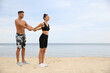 © New Africa - Couple doing exercise together on beach, space for text. Body training