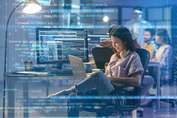 Wall Mural - female programmer working with laptop in office at night