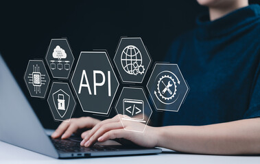 api application programming interface concept. a person types on laptop, with digital icons represen
