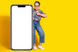 © deagreez - Full length photo of lovely senior lady big smartphone thumb up dressed stylish colorful garment isolated on yellow color background