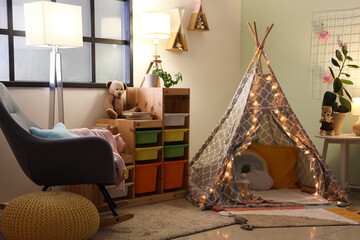 Wall Mural - Interior of stylish children's bedroom with play tent, glowing lights and toys at night