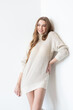 © alipko - young beautiful woman in a white sweater and long legs