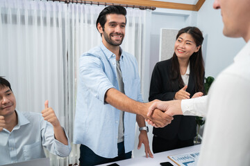 Fototapete - Diverse group of office employee worker shake hand after making agreement on strategic business marketing meeting. Teamwork and positive attitude create productive and supportive workplace. Prudent