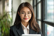 © Suchithra - Young Asian Woman Wearing a Sharp Business Suit, Exuding Confidence and Professionalism in a Modern Office Setting, Representing Ambition, Style, and Career Success