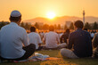 © Andri - A scene of people performing the Eid al-Fitr prayer in an open field at sunrise, with the sun casting a golden glow over the congregation.