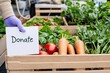 © Olga - Close-up of a wooden crate filled with fresh organic produce ready for charity donation