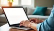 © miss irine - Person working on laptop indoors. Hands type on keyboard. Blank screen laptop mockup. Office setting. Possible home office environment. Modern tech use. Focus on tech tools. Business personal work.
