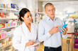 © JackF - Female specialist is helping male client choose medicine in pharmacy