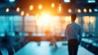 © Dounonji - A person stands in a dimly lit office space, illuminated by warm light, with a modern ambiance and a focus on creativity and inspiration.