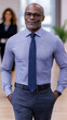 © Siasart Stock - Confident Businessman Stands with Hands in Pockets, Displaying Professional Attire in Office Setting.