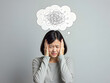 © MUHAMMAD - Stressed woman with tangled thoughts depicted in thought bubble above her head