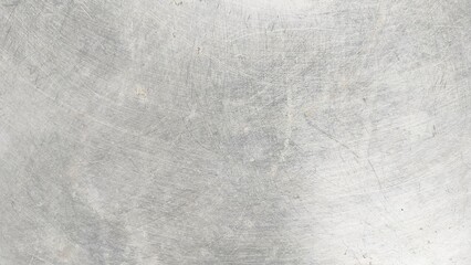 close-up of a scratched metal surface, possibly stainless steel or aluminum. the texture is rough, w