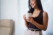 © Crystal - Young businesswoman drinking coffee during a break in the office