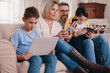 © peopleimages.com - Family, tech bonding and network in home, internet subscription and multiple membership on couch. Parents, children and media entertainment for boys in living room, love and website for streaming