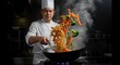 © Ulfiatul Savira - A chef tossing noodles in a wok with colorful vegetables and soy sauce.