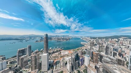 Poster - A 4K still video frame offers a zoomed-out aerial view of Hong Kong's vibrant cityscape, showcasing its skyscrapers and harbor under a bright blue sky.