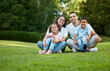 © peopleimages.com - Kids, portrait or happy family in nature with love, care or smile on grass for bonding together on holiday. Parents, relax and father in garden with children, mother or daughter on outdoor vacation