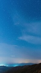 Wall Mural - mountains, city and endless night sky, time lapse, vertical view