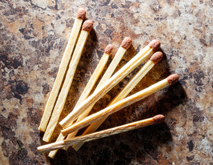 A pile of matches with a red tip