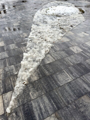 Wall Mural - A large ice sculpture is on a brick walkway