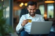 © Premium Illustration - Smiling young man with dark hair and beard holding gold credit card using silver laptop shopping online ecommerce digital payment business office interior warm light