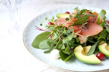 Wall Mural - Avocado and smoked red fish salad on a white plate