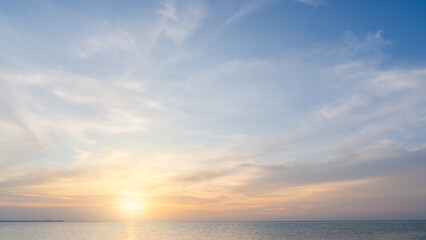 Wall Mural - sunset sky clouds over sea in the evening with orange, yellow sunlight, horizon sea landscape backgr