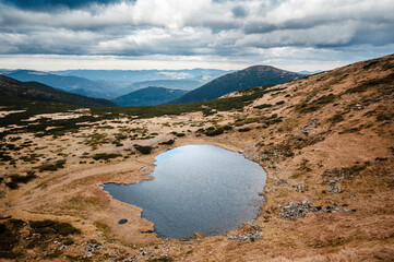 Wall Mural - Serene Mountain Lake with Reflective Waters