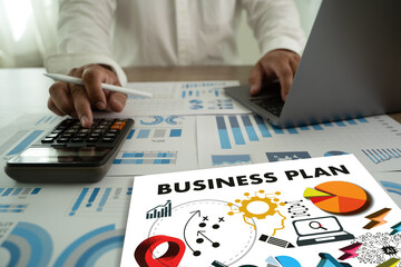 Wall Mural - business plan business project finance investment concept The plan is spread out on a table with a laptop