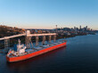 © AmazingAerialAgency - Aerial view of cargo ship and grain terminal with Seattle skyline at sunset, Elliot Bay, United States.