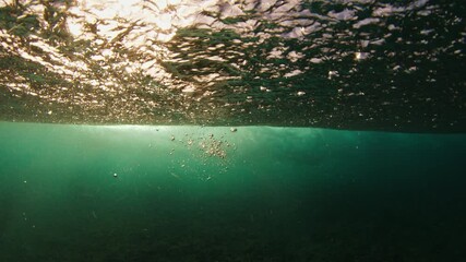 Fototapete - Underwater view of powerful ocean wave. Wave rolls and breaks. Maldives