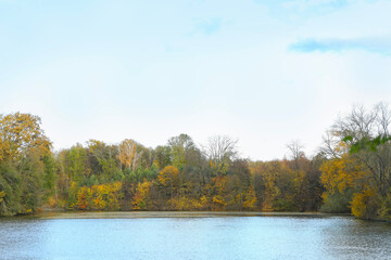 Wall Mural - Lake surrounded by trees in autumn. Picturesque landscape