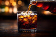 © AgungRikhi - Pouring Dark Cola into Icy Glass on Dark Background