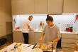 © teksomolika - A couple is joyfully cooking together in their stylish and modern kitchen environment