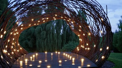 Fototapete - Intricate light installation creates a magical atmosphere in an outdoor space during twilight