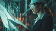 © Teeraphon - A beautiful female engineer is designing the workings of a mechanical arm in an industrial factory.