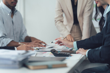 Wall Mural - Strategic Brainstorming: A close-up shot of a diverse group of professionals engaged in a collaborative brainstorming session around a conference table.