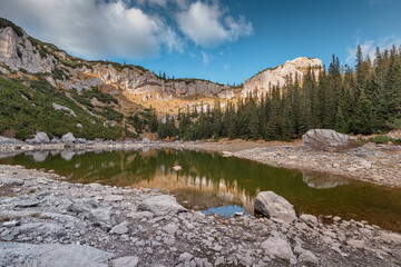 Wall Mural - Scenic alpine lake Jablan reflecting cliffs and trees in autumn, Durmitor National Park, Montenegro