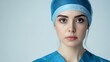 © Alloca Design Studio - close up portrait of a female doctor or nurse wearing a blue uniform and medical cap on her head