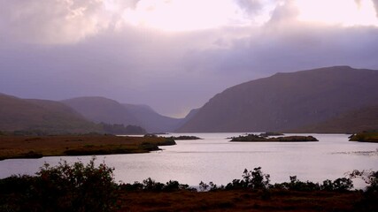 Wall Mural - Glenveagh National Park in Donegal Ireland - A breathtaking view showcasing a tranquil lake embraced by verdant greenery and grand mountains during sunrise