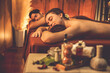 © InfiniteFlow - Caucasian couple customer enjoying relaxing anti-stress spa massage and pampering with beauty skin recreation leisure in warm candle lighting ambient salon spa at luxury resort or hotel. Quiescent