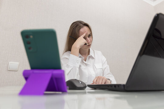 Fototapete -  - Female person office worker or freelancer works in office or at home at computer. Business woman concentration look in laptop screen, she's not doing very well at work. People thought while working.
